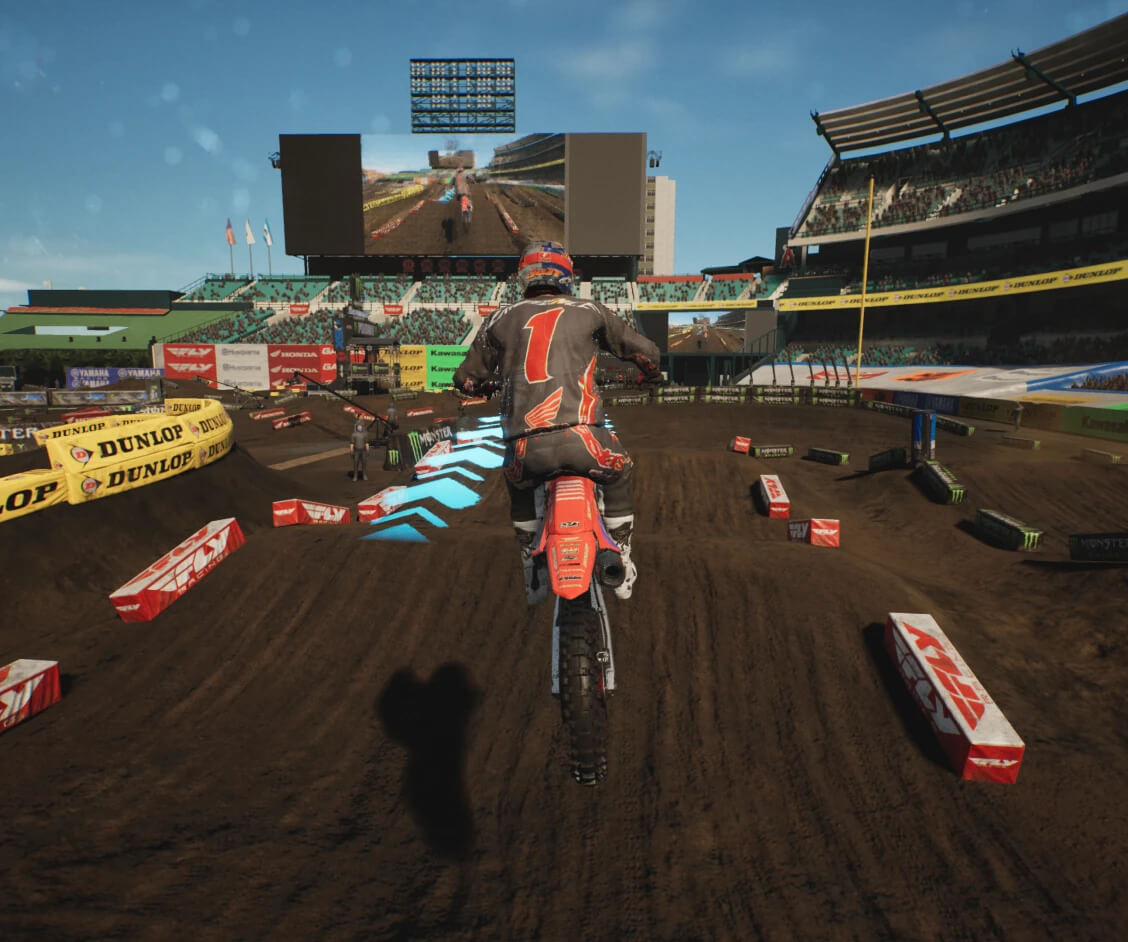 imagem do jogo Monster Energy Supercross 25 mostrando a movimentação do piloto em cima da moto durante um salto na pista de supercross