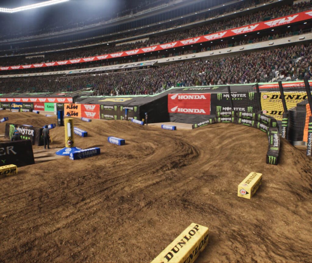 imagem do jogo Monster Energy Supercross 25 mostrando a física realista da unreal engine 5 e a pista dinâmica, com canaletas, buracos e ondulações na pista de motocross durante a corrida.